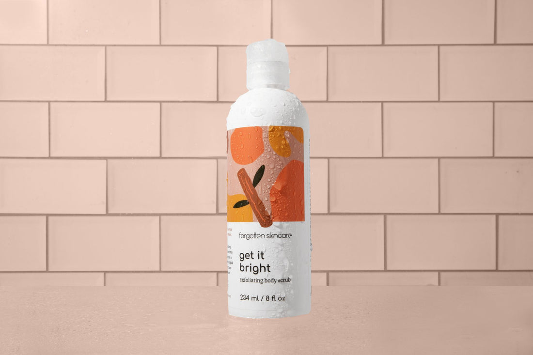 glycolic acid body scrub in pink tile bathroom with water