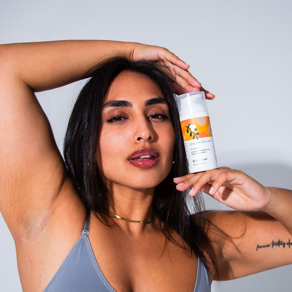 Woman holding bottle of Forgotten Skincare